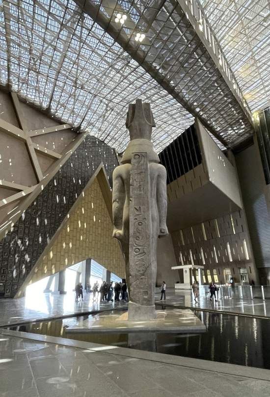 Professional Egyptologist standing outside the Grand Egyptian Museum before a private Cairo tour.