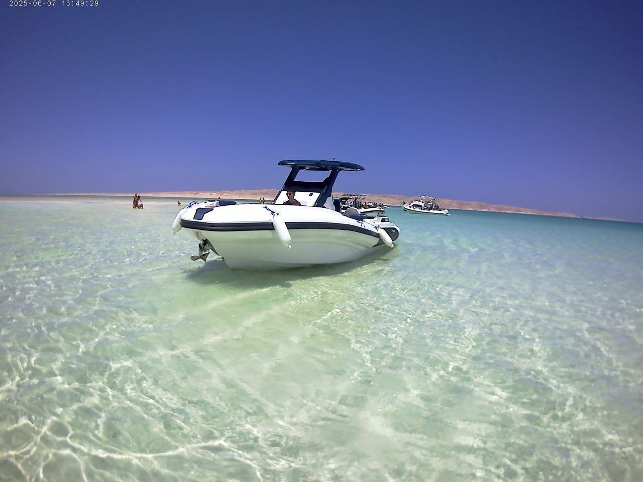 Tourists relaxing under the sun on Bayoud Island during a private Red Sea speed boat excursion from Hurghada./