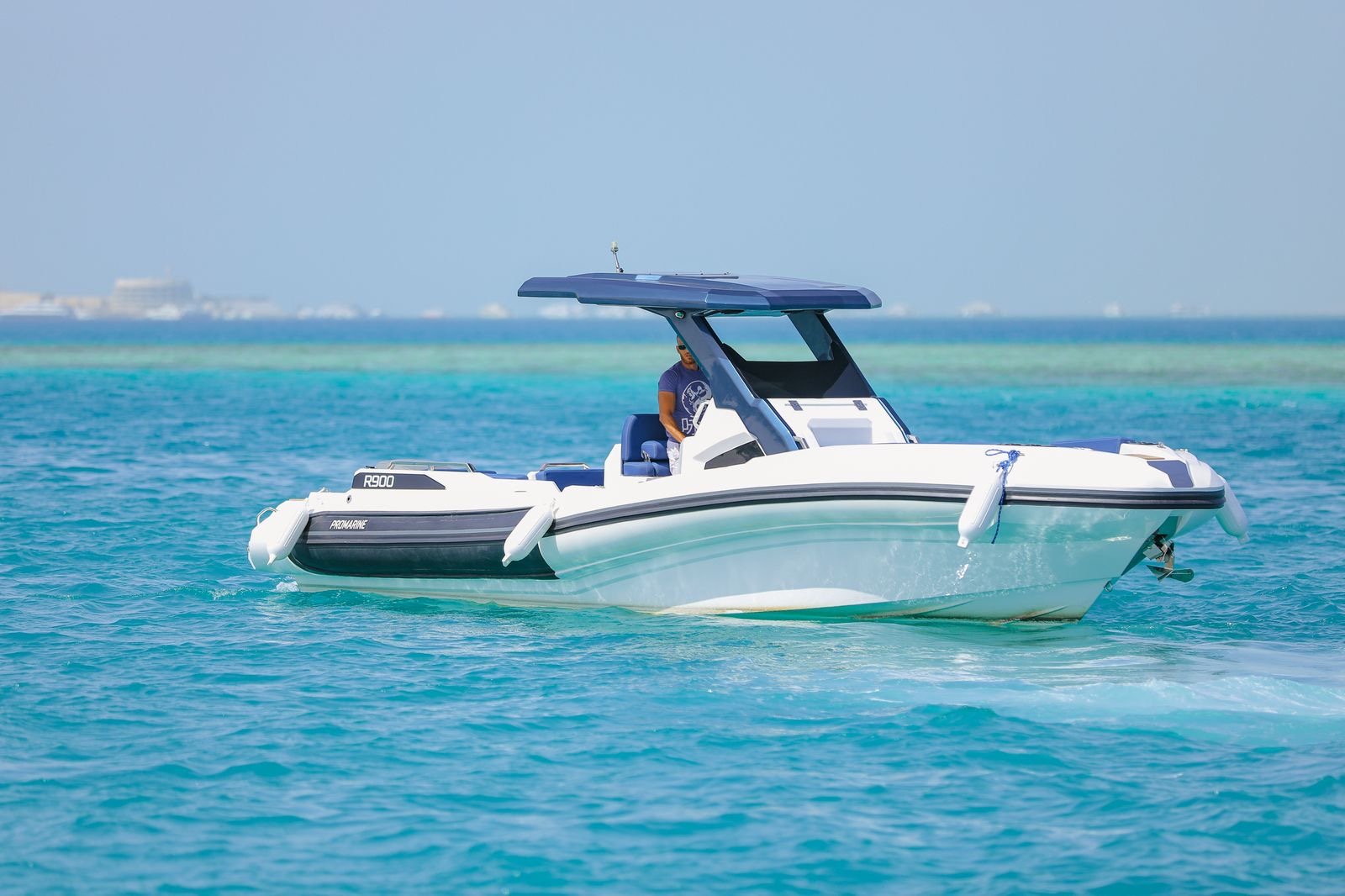 Tourists relaxing under the sun on Bayoud Island during a private Red Sea speed boat excursion from Hurghada....