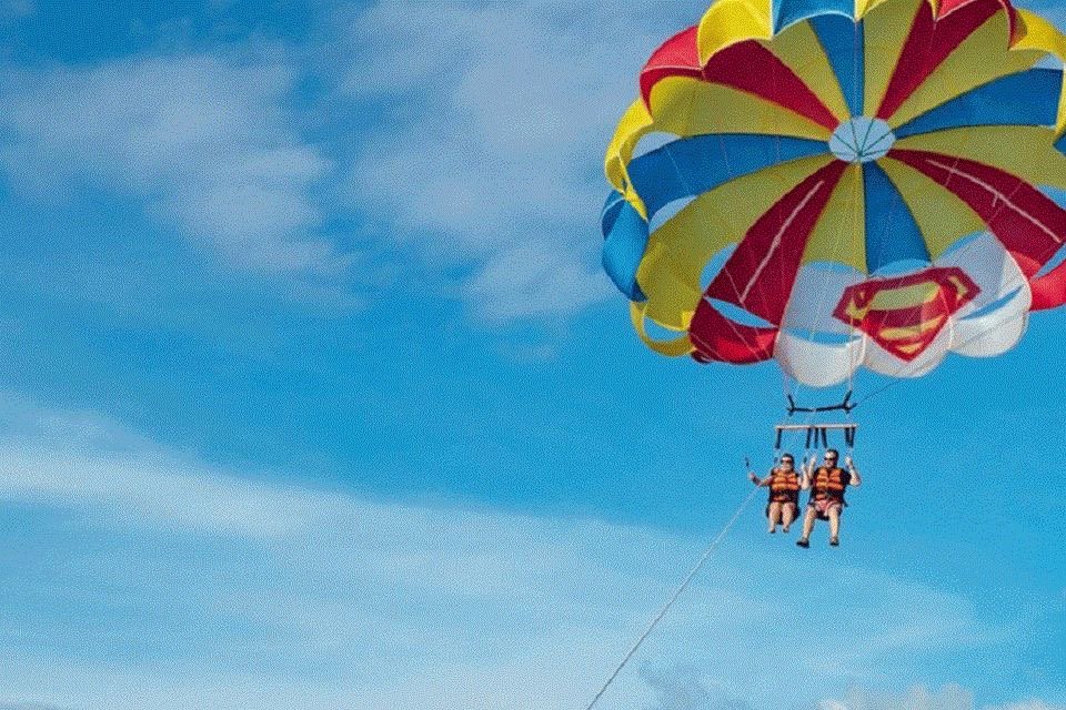 Solo parasailing takeoff — panoramic Hurghada coastline views.
