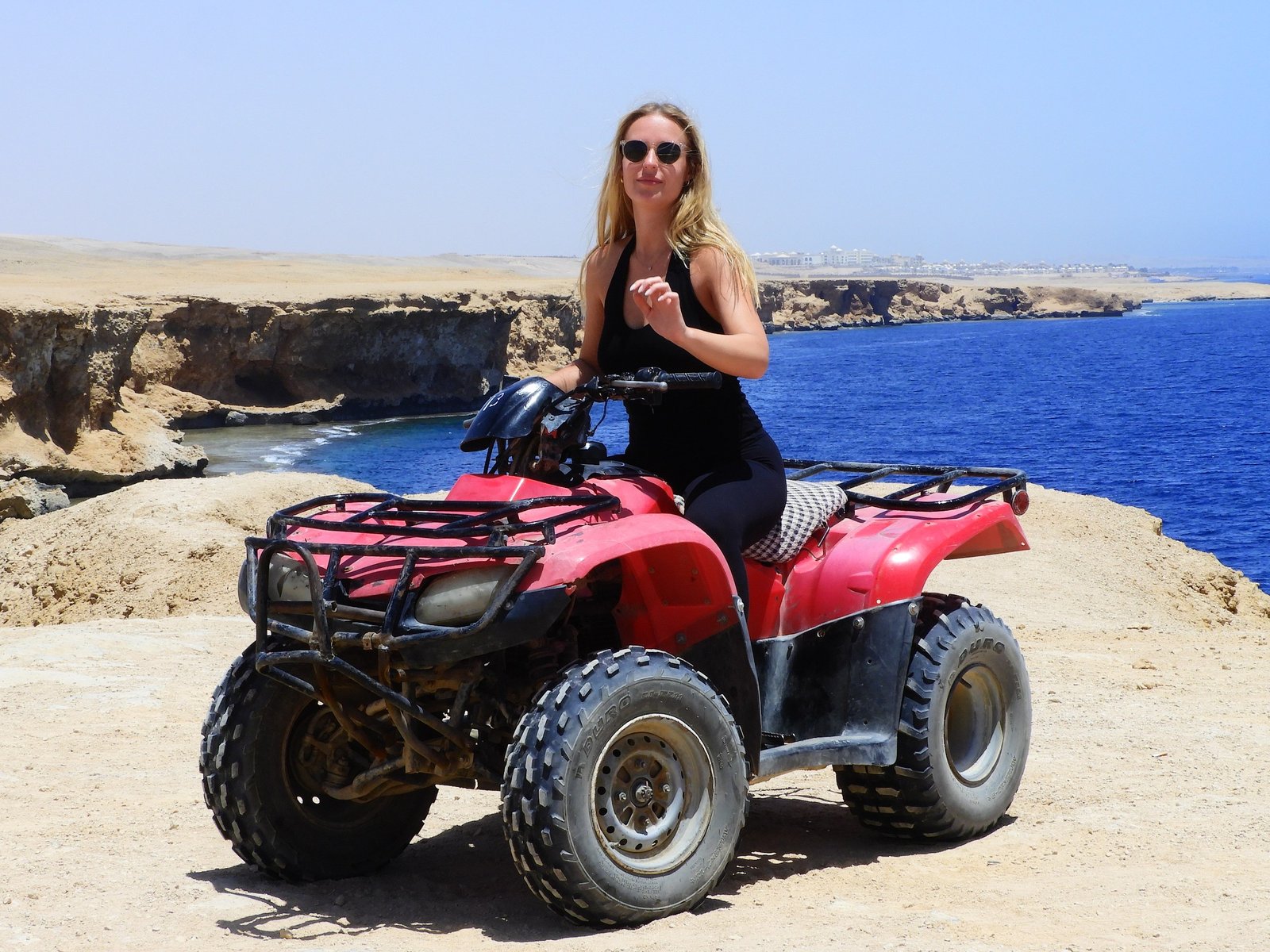 Chase the sun across golden dunes on the Desert Quad Safari Hurghada Sunset.-