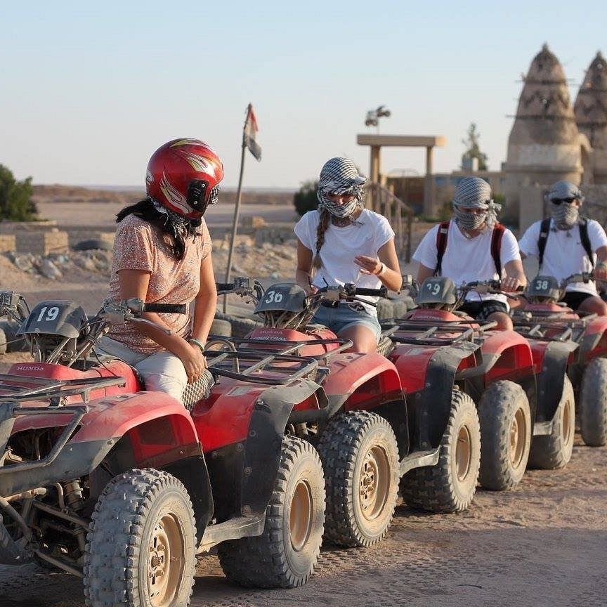 Chase the sun across golden dunes on the Desert Quad Safari Hurghada Sunset.//
