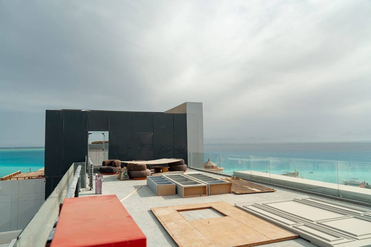 Underwater image of snorkelers exploring colorful coral gardens near Ozirea Island Hurghada with visible reef fish and excellent water clarity; emphasizes marine life, visibility and family‑friendly reef access.