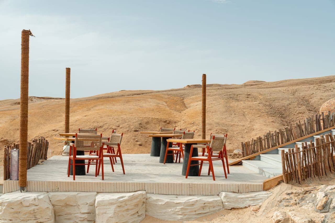 Underwater image of snorkelers exploring colorful coral gardens near Ozirea Island Hurghada with visible reef fish and excellent water clarity; emphasizes marine life, visibility and family‑friendly reef access.